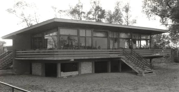 Schwarzweißfoto von 1964: das feste Haus auf Stelzen mit Außentreppe und umlaufendem Balkon